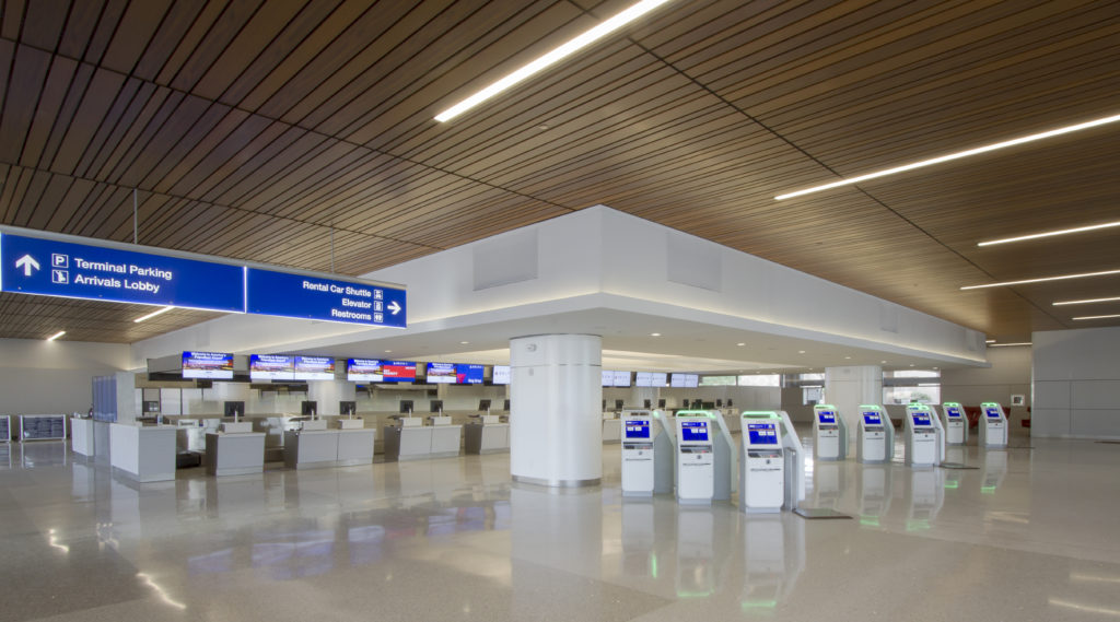 Metal Linear Multi-Box Continuous ceiling systems resembling individual wood slats were specified for lower levels along security checkpoints. The linear system required precise design, planning, and installation due to its modular nature and randomized perpendicular lighting.