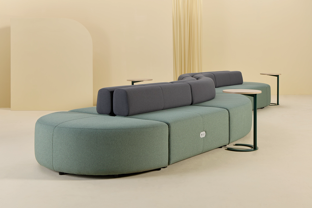 Zeker curved and linear plush seating configurations - sage green with charcoal backrests and mobile tables