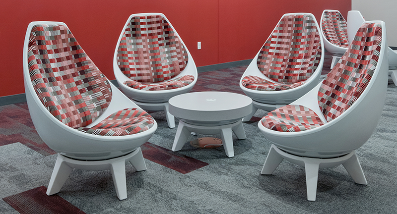 Sway lounge seating - cup-like rounded back with red and black cushions