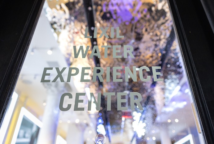 LIXIL Water Experience Center exterior door with name, reflecting rippled silver ceiling